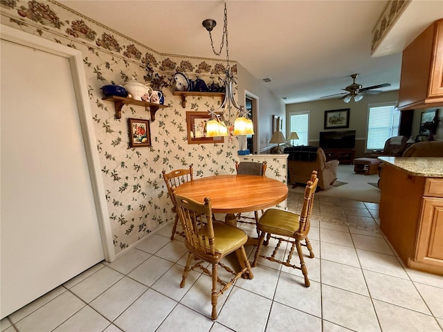 8111 Merrimac Dr, Port Richey, FL 34668 - dining room with wallpapered walls, ceiling fan, and light tile patterned floors