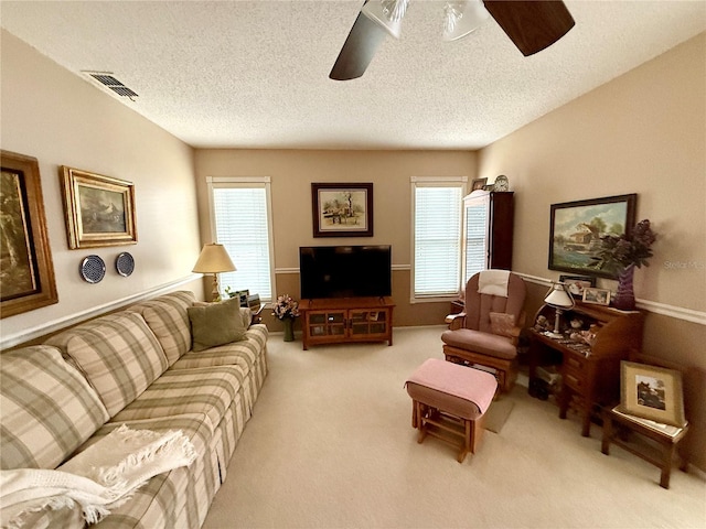 8111 Merrimac Dr, Port Richey, FL 34668 - carpeted living area with ceiling fan, plenty of natural light, and a textured ceiling