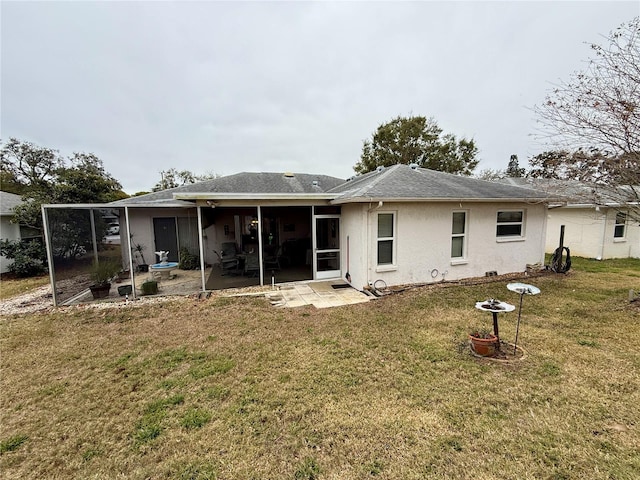 8111 Merrimac Dr, Port Richey, FL 34668 - rear view of property featuring a patio, a yard, a sunroom, stucco siding, and a shingled roof