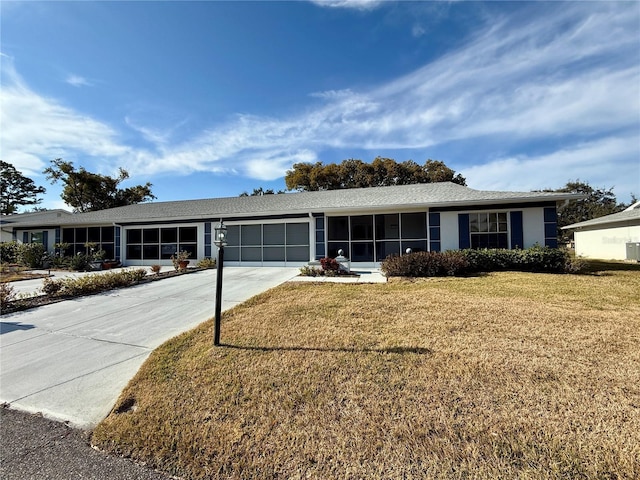 single story home featuring a garage and a front lawn