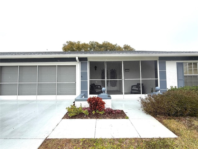 doorway to property with a garage