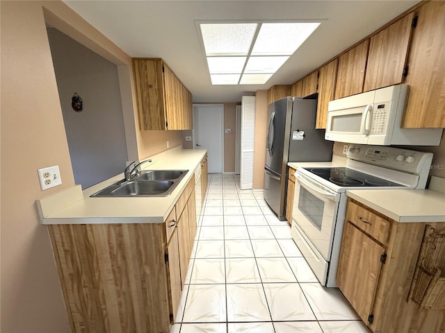 kitchen featuring sink, white appliances, and light tile patterned floors