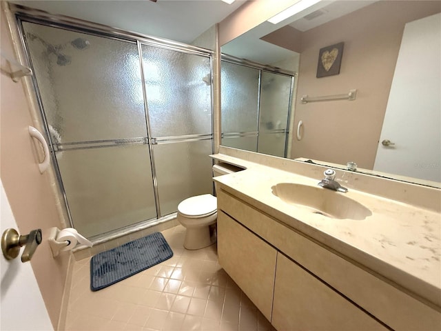 bathroom with vanity, a shower with shower door, tile patterned floors, and toilet