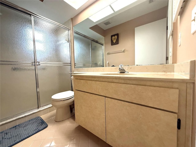 bathroom featuring tile patterned flooring, vanity, toilet, and an enclosed shower