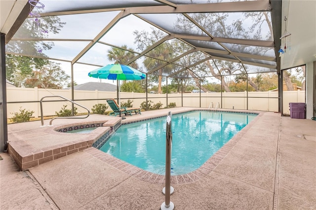 view of pool with a patio, a lanai, and an in ground hot tub