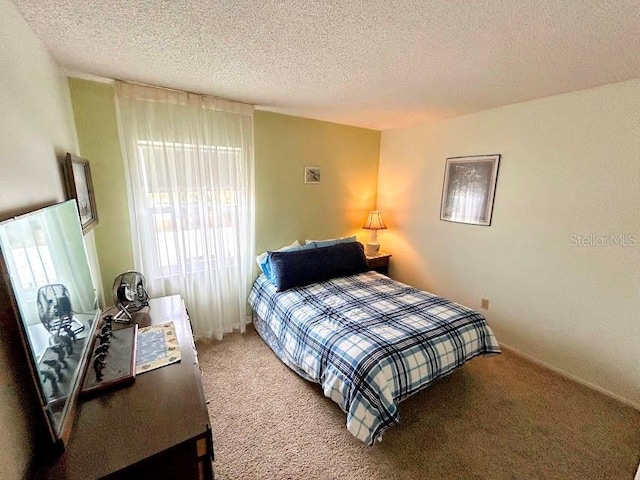 carpeted bedroom featuring a textured ceiling