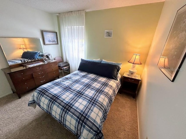 carpeted bedroom with a textured ceiling