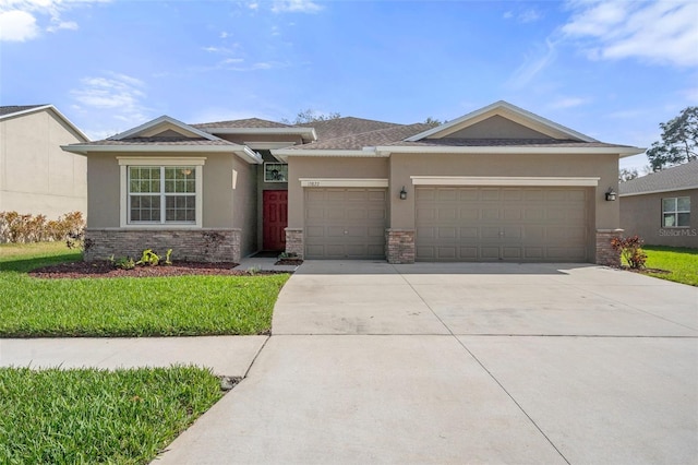 view of front of property featuring a garage, concrete driveway, stone siding, and stucco siding