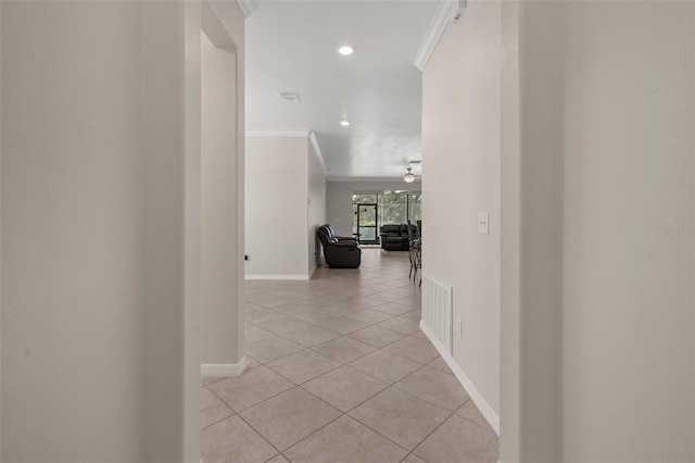 hallway with light tile patterned floors, recessed lighting, baseboards, and crown molding