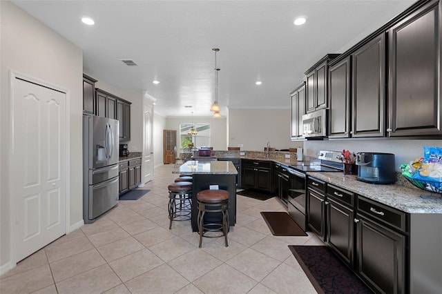 kitchen featuring light tile patterned floors, light stone counters, stainless steel appliances, and a kitchen breakfast bar