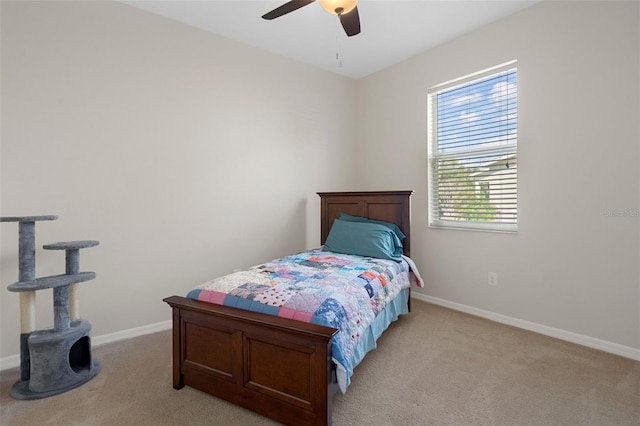 bedroom with light colored carpet, ceiling fan, and baseboards