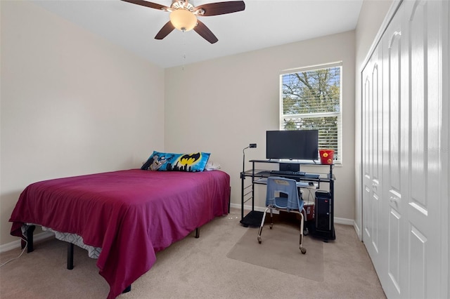 bedroom featuring carpet floors, a closet, baseboards, and a ceiling fan