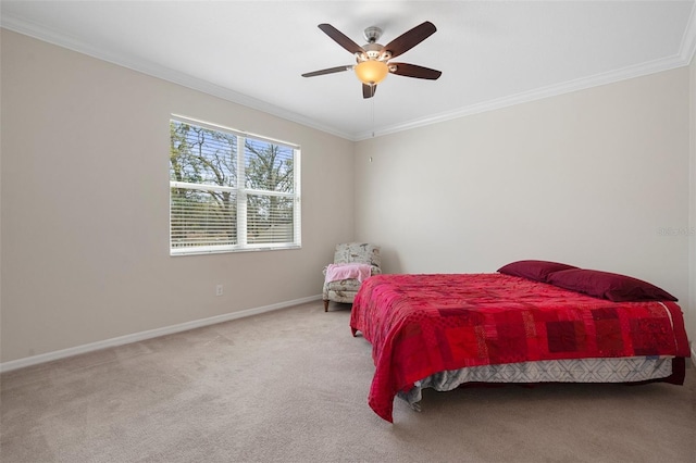 carpeted bedroom with a ceiling fan, crown molding, and baseboards