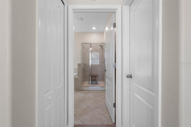 hall with light tile patterned floors