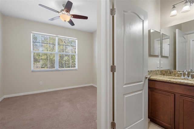 bathroom featuring ceiling fan, vanity, and baseboards