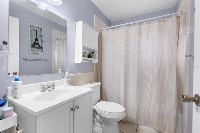 full bathroom featuring toilet, shower / bath combo, tile walls, tile patterned floors, and vanity