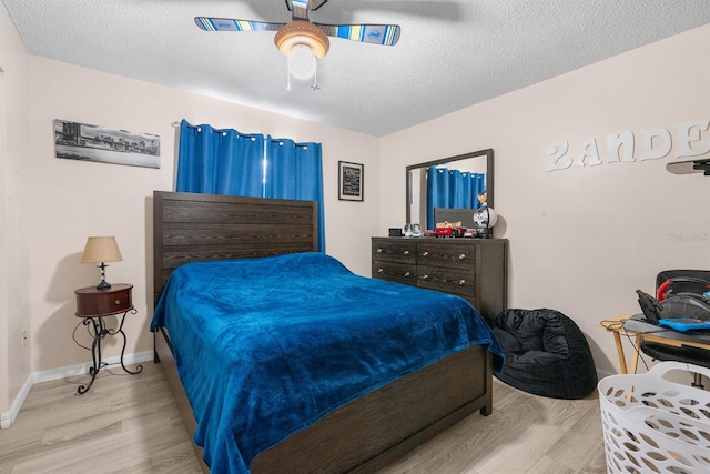 bedroom featuring ceiling fan, a textured ceiling, and hardwood / wood-style floors