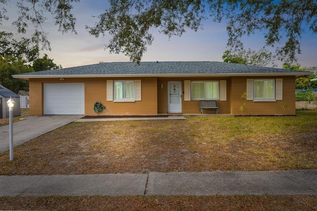 ranch-style home with a lawn and a garage