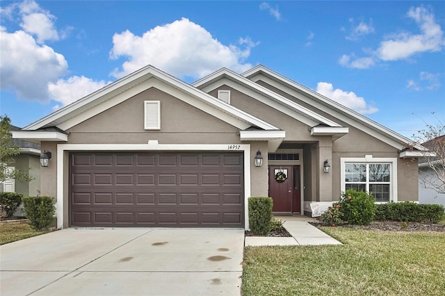 view of front of house with a front yard and a garage