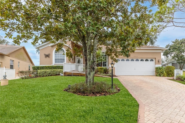 view of front of property featuring a garage and a front yard