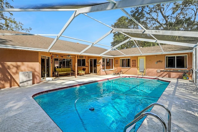 view of pool with a patio area and a lanai