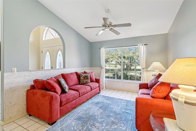 living room with ceiling fan, light tile patterned floors, vaulted ceiling, and french doors