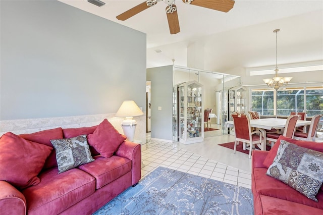 tiled living room featuring ceiling fan with notable chandelier