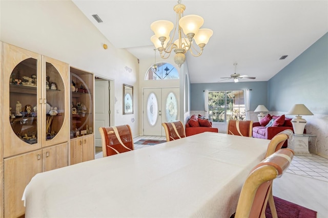 dining room featuring lofted ceiling and ceiling fan with notable chandelier