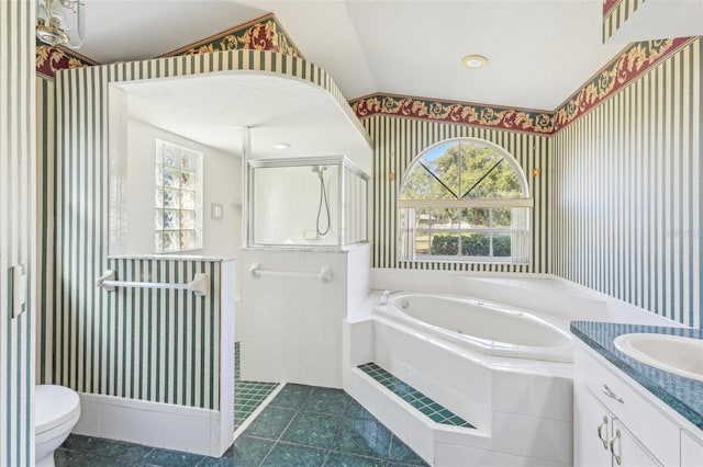 full bathroom with lofted ceiling, tile patterned floors, vanity, toilet, and independent shower and bath