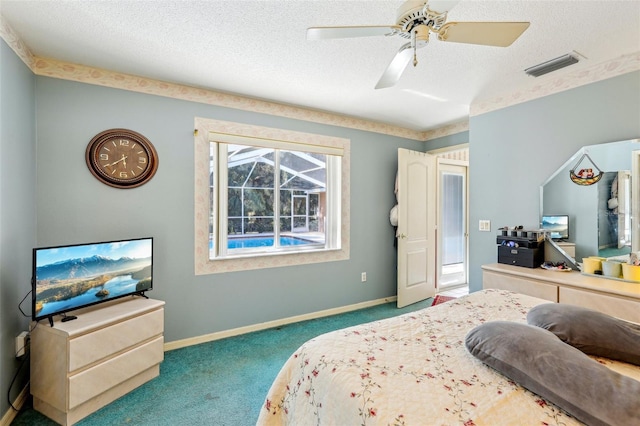 bedroom featuring ceiling fan, a textured ceiling, and carpet floors