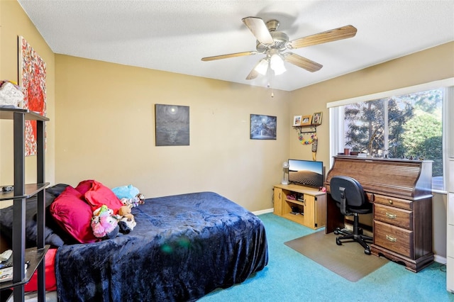 bedroom with a textured ceiling, ceiling fan, and carpet floors