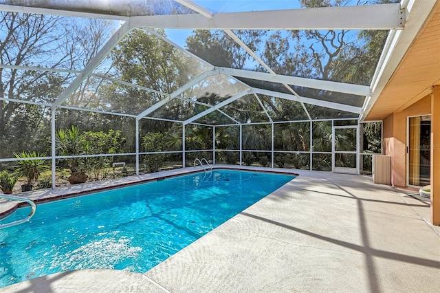 view of swimming pool with a lanai and a patio