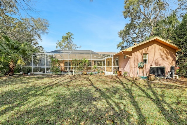 back of property with a lanai, a yard, and central AC