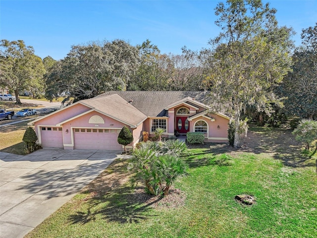 ranch-style home featuring a front lawn and a garage