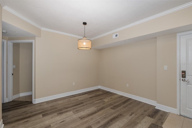 unfurnished room featuring hardwood / wood-style flooring and ornamental molding