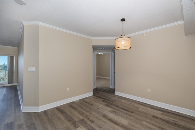 empty room with ornamental molding and dark hardwood / wood-style flooring