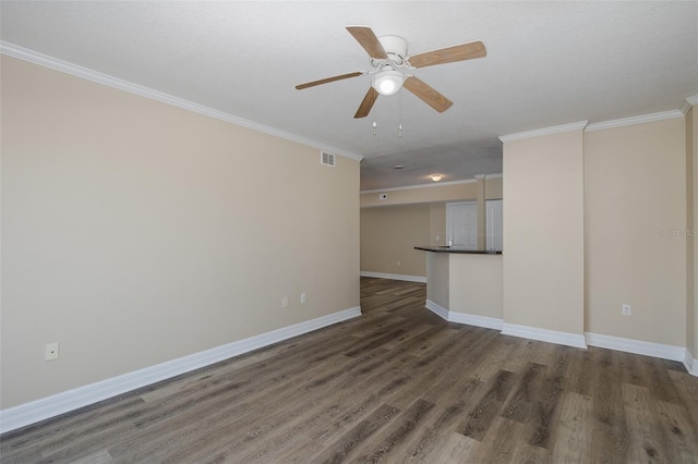 empty room featuring ceiling fan, dark hardwood / wood-style floors, and ornamental molding