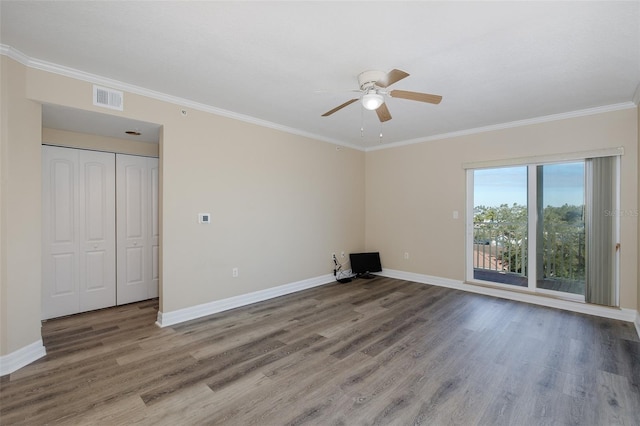 empty room featuring ceiling fan, hardwood / wood-style floors, and crown molding