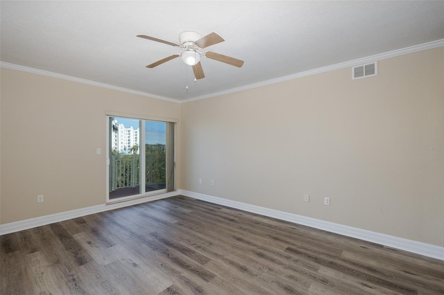 empty room featuring ceiling fan, dark wood-type flooring, and ornamental molding