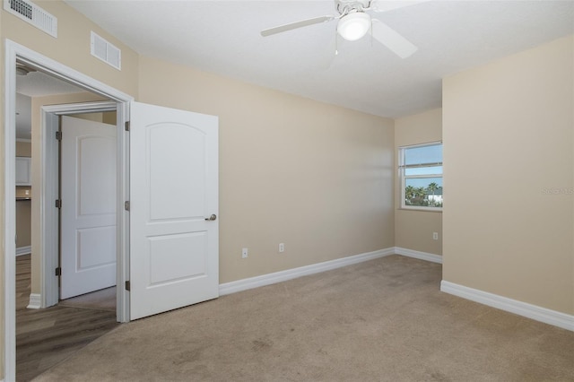 carpeted empty room with ceiling fan