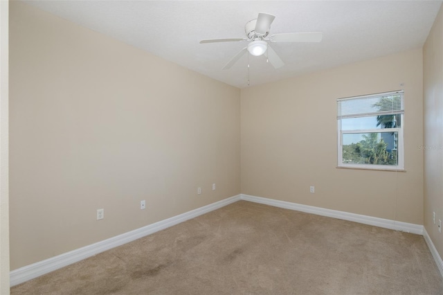 spare room featuring ceiling fan and light colored carpet