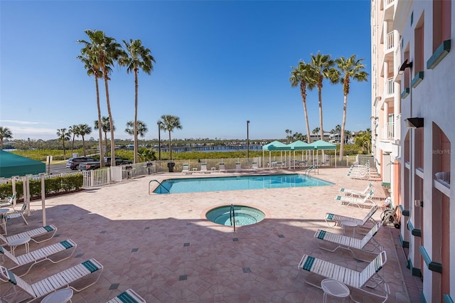 view of pool with a community hot tub and a patio area