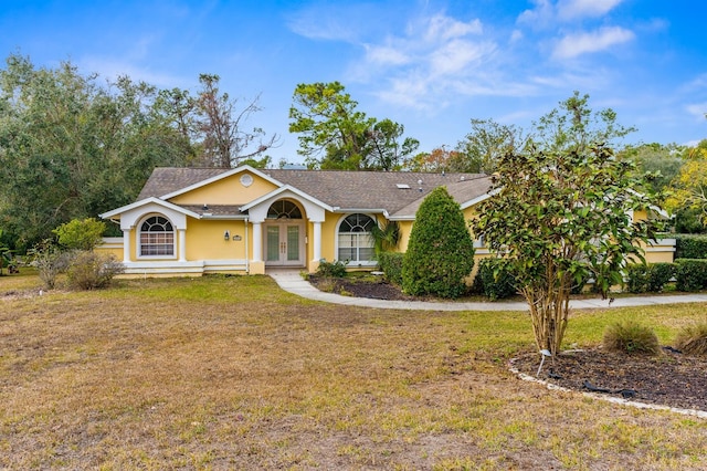 ranch-style house featuring french doors and a front yard