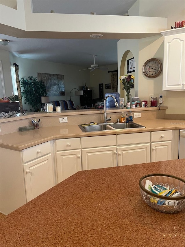 kitchen featuring ceiling fan, white cabinetry, and sink