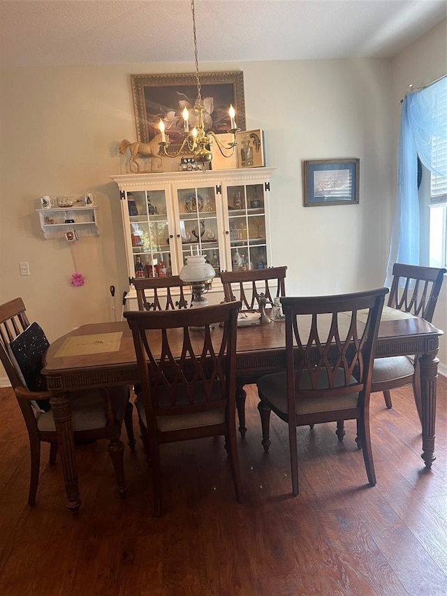 dining room with wood-type flooring and a notable chandelier