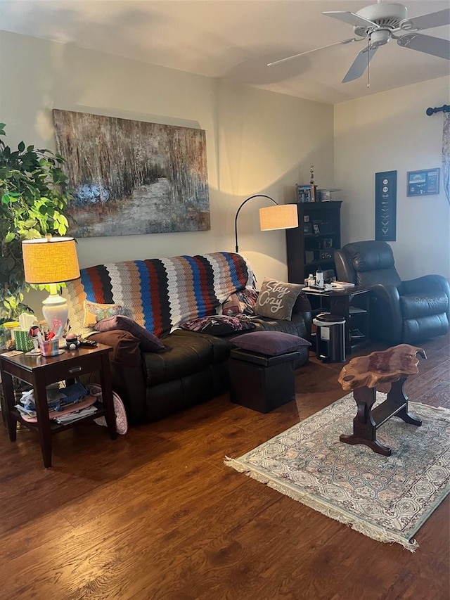 living room featuring ceiling fan and hardwood / wood-style floors