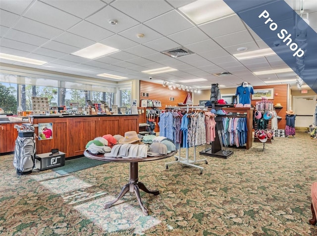 misc room featuring visible vents, a drop ceiling, and carpet flooring