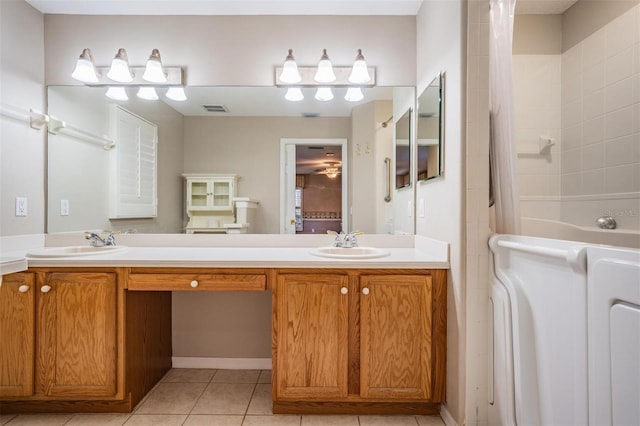 bathroom featuring a sink, visible vents, double vanity, and tile patterned flooring