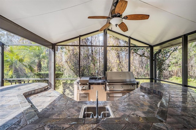 view of patio featuring a sink, area for grilling, a lanai, and ceiling fan