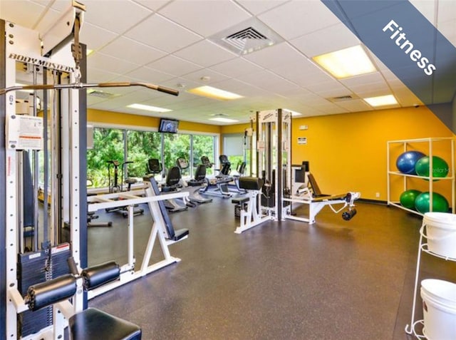 workout area with visible vents and a drop ceiling